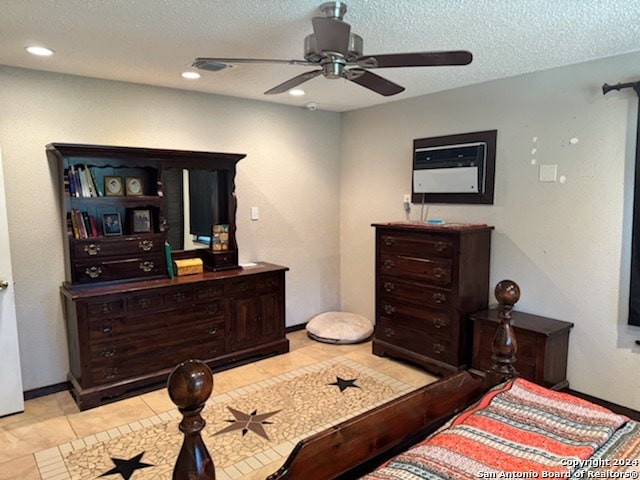 bedroom featuring ceiling fan, a textured ceiling, and light tile patterned flooring