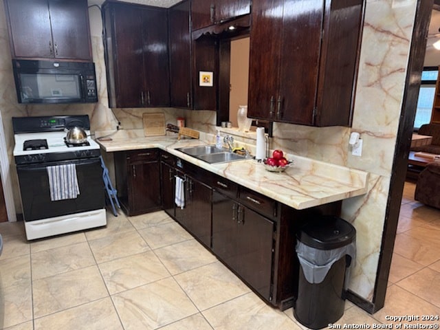 kitchen featuring white range with electric cooktop and dark brown cabinetry