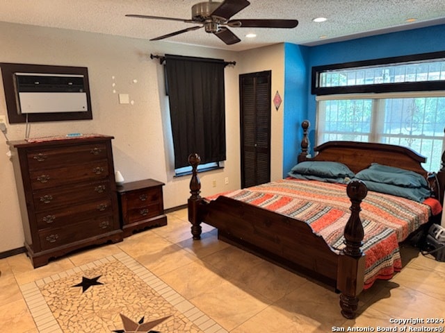 tiled bedroom featuring a textured ceiling, ceiling fan, and a closet