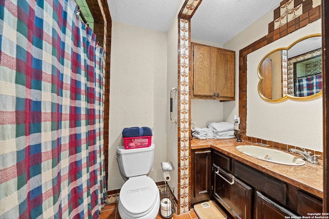 bathroom with a textured ceiling, vanity, a shower with shower curtain, toilet, and tile patterned floors