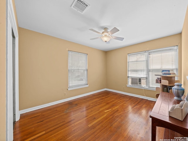 interior space featuring cooling unit, hardwood / wood-style floors, and ceiling fan