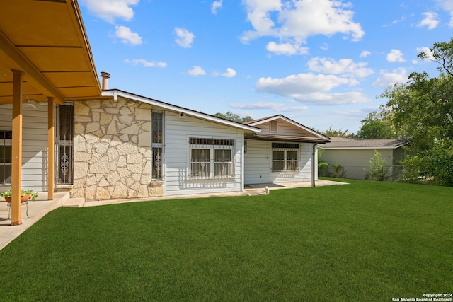 rear view of house with a yard