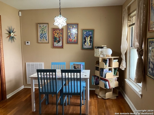 dining room featuring dark hardwood / wood-style flooring and a healthy amount of sunlight