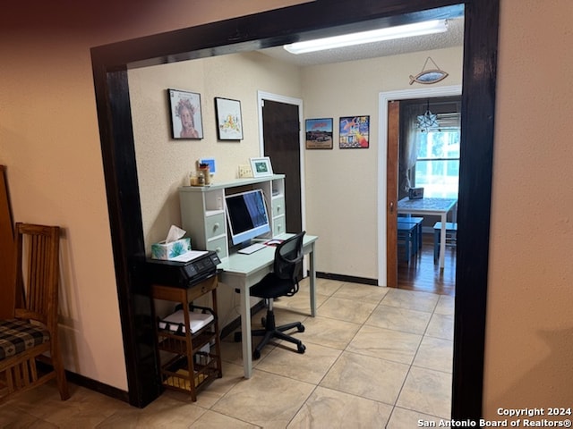 tiled office featuring a chandelier