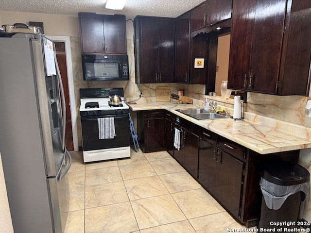 kitchen featuring white range with electric stovetop, sink, dark brown cabinets, and stainless steel refrigerator with ice dispenser