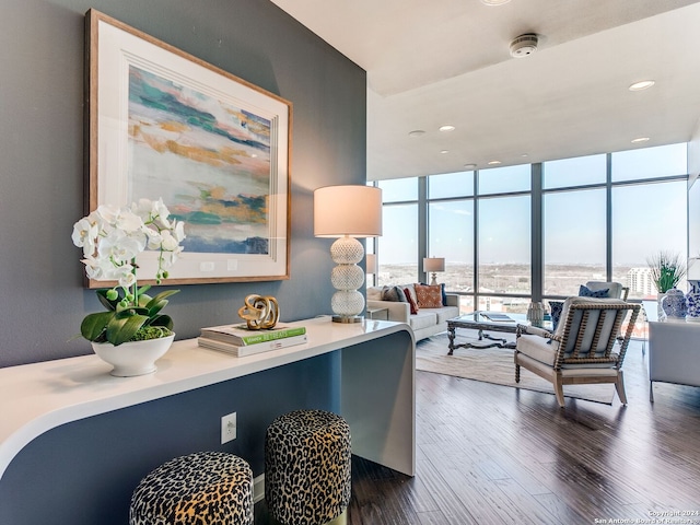 office space with floor to ceiling windows and dark hardwood / wood-style flooring