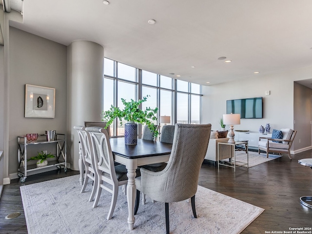 dining room featuring a wall of windows and hardwood / wood-style floors