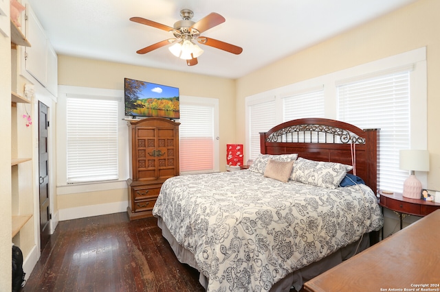 bedroom with dark hardwood / wood-style floors and ceiling fan