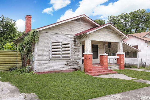 view of front of house with a front lawn and a porch