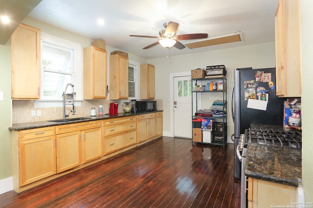 kitchen featuring gas stove, dark wood-type flooring, sink, and light brown cabinetry