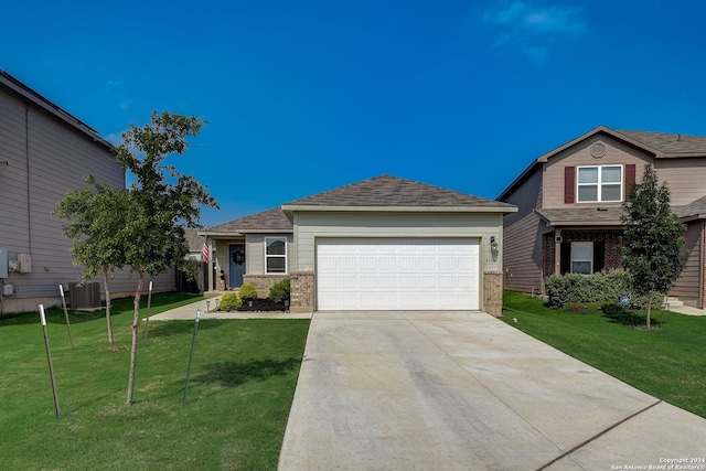 view of front facade with a garage, a front lawn, and central AC unit