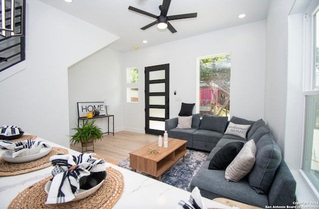 living room featuring dark hardwood / wood-style floors and ceiling fan