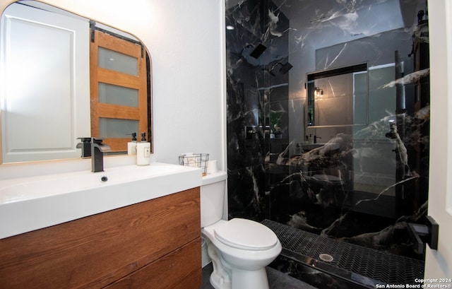 bathroom with a shower with door, toilet, tile floors, and vanity