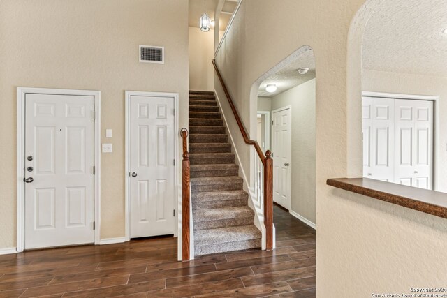 entrance foyer featuring dark hardwood / wood-style floors and a textured ceiling