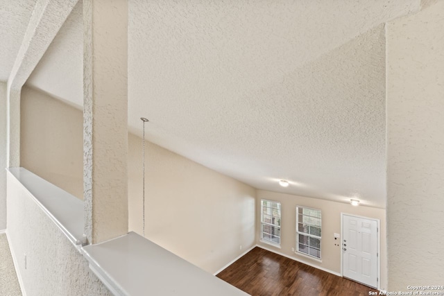 interior space featuring dark hardwood / wood-style floors and a textured ceiling