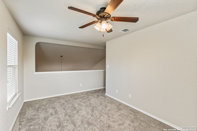 carpeted spare room with ceiling fan