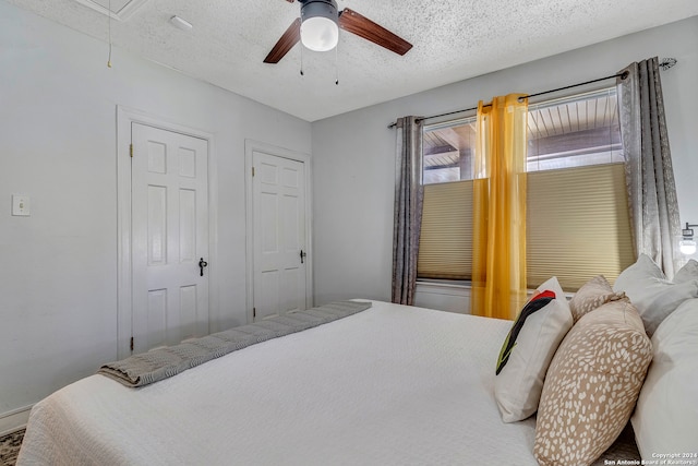 bedroom with a textured ceiling and ceiling fan