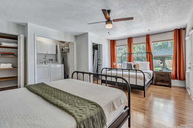 bedroom with washer and clothes dryer, light hardwood / wood-style floors, ceiling fan, and a textured ceiling