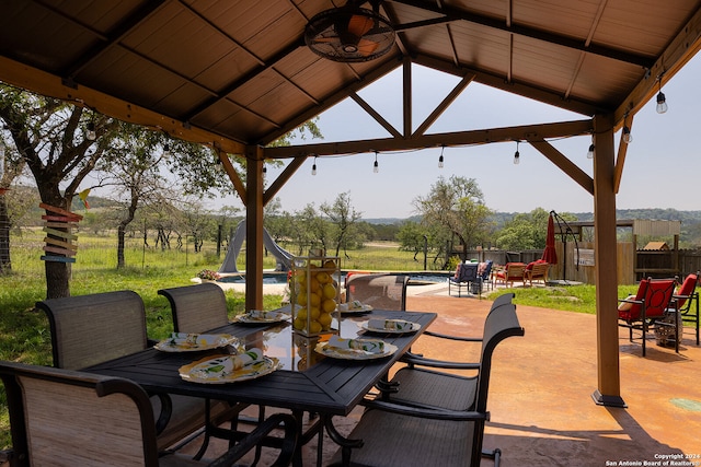 view of patio featuring a gazebo and a swimming pool