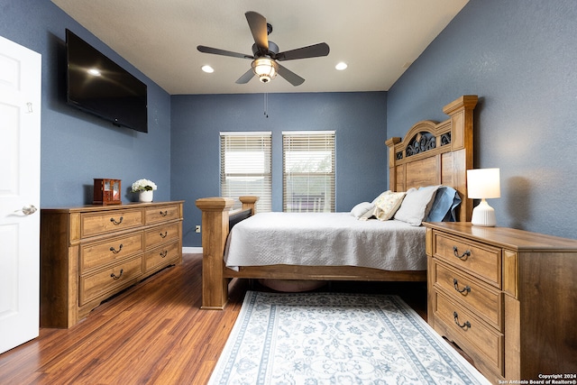 bedroom with ceiling fan and dark hardwood / wood-style flooring