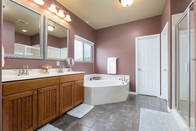 bathroom featuring independent shower and bath, vanity, and tile patterned flooring