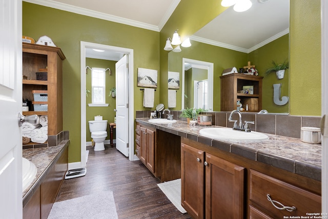 bathroom with hardwood / wood-style flooring, vanity, crown molding, and toilet