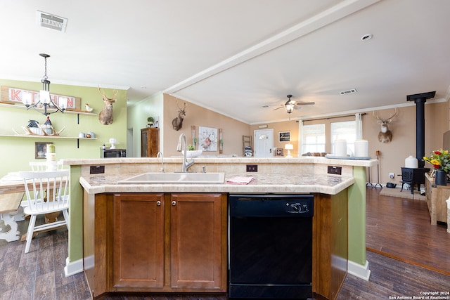 kitchen with sink, dishwasher, an island with sink, decorative light fixtures, and a wood stove