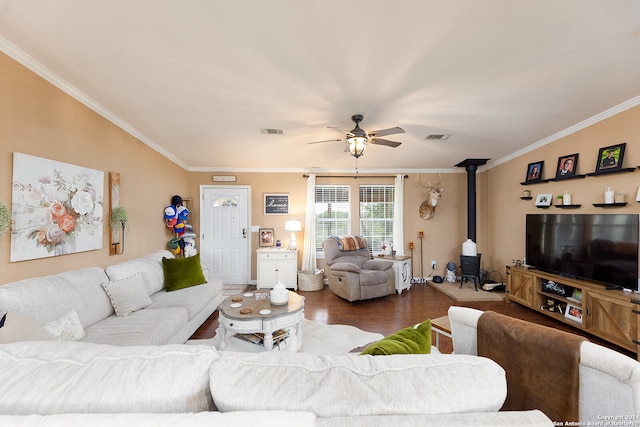 living room featuring ornamental molding, wood-type flooring, a wood stove, and ceiling fan