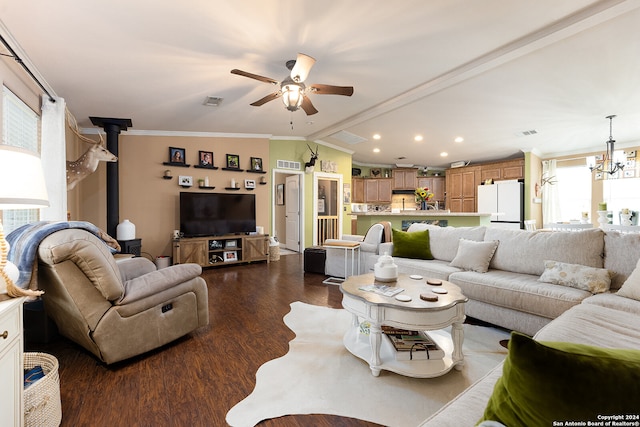 living room featuring ornamental molding, a wood stove, ceiling fan with notable chandelier, and dark hardwood / wood-style flooring