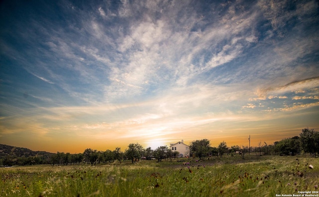 nature at dusk featuring a rural view