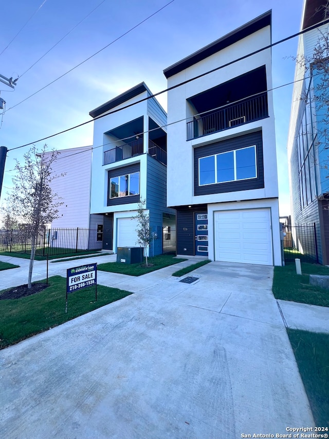 view of front of home with a balcony and a garage