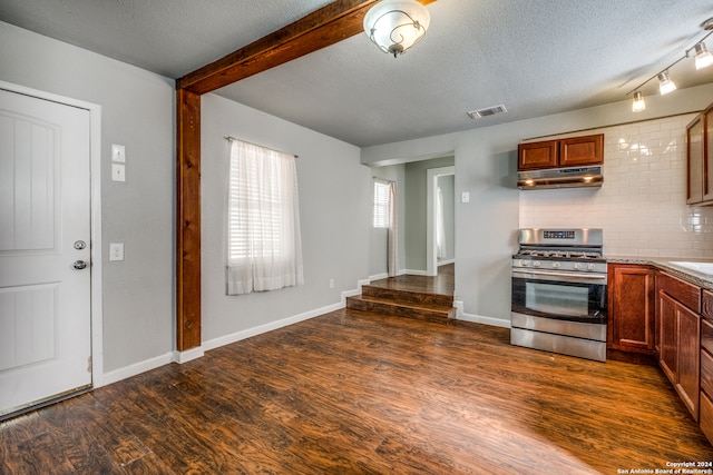 kitchen with gas stove, backsplash, dark wood-type flooring, and a textured ceiling