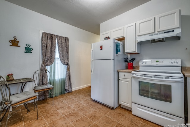 kitchen with white appliances, white cabinetry, and light tile floors