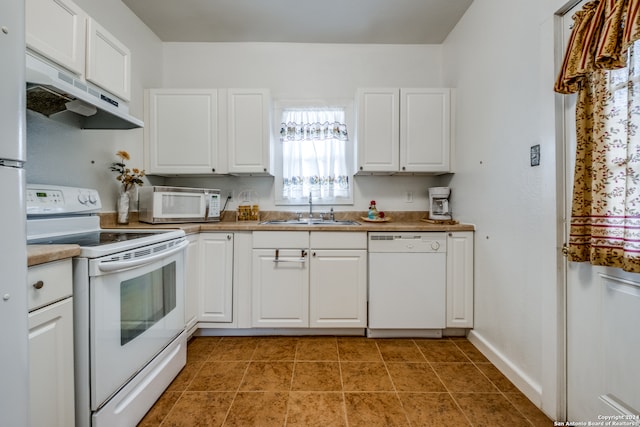 kitchen featuring white cabinets, sink, white appliances, and tile floors