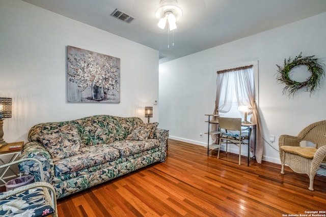 living room with hardwood / wood-style flooring and ceiling fan