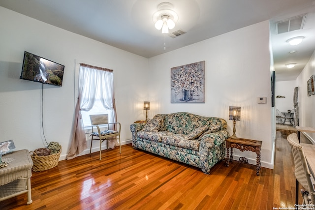 living room with ceiling fan and hardwood / wood-style flooring