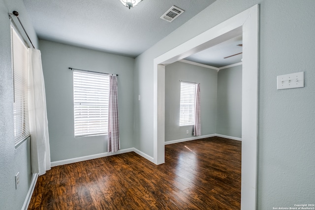 unfurnished room featuring wood-type flooring, ceiling fan, and a textured ceiling