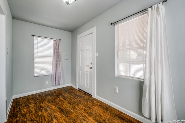 unfurnished room with hardwood / wood-style flooring and a wealth of natural light