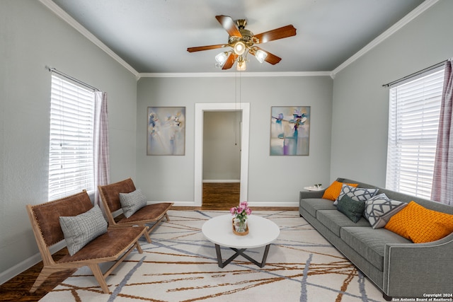 living room with wood-type flooring, plenty of natural light, ceiling fan, and crown molding