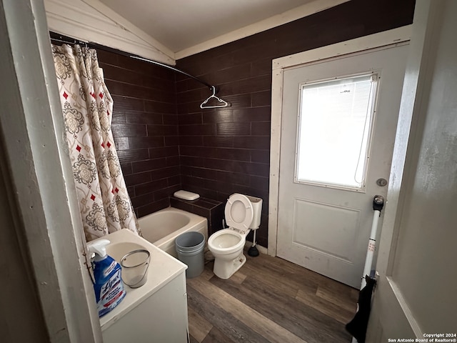 full bathroom featuring shower / bath combination with curtain, vanity, hardwood / wood-style flooring, toilet, and lofted ceiling