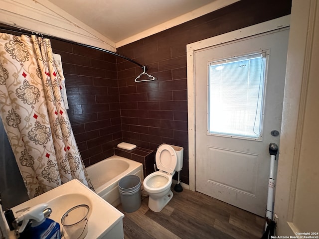 full bathroom with shower / bath combo with shower curtain, vanity, hardwood / wood-style floors, toilet, and lofted ceiling