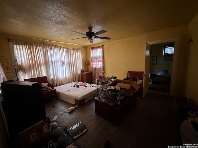 bedroom with wood-type flooring, a textured ceiling, and ceiling fan