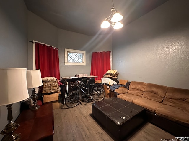 living room featuring lofted ceiling and light hardwood / wood-style floors