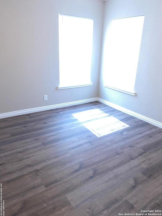 unfurnished room featuring dark hardwood / wood-style flooring