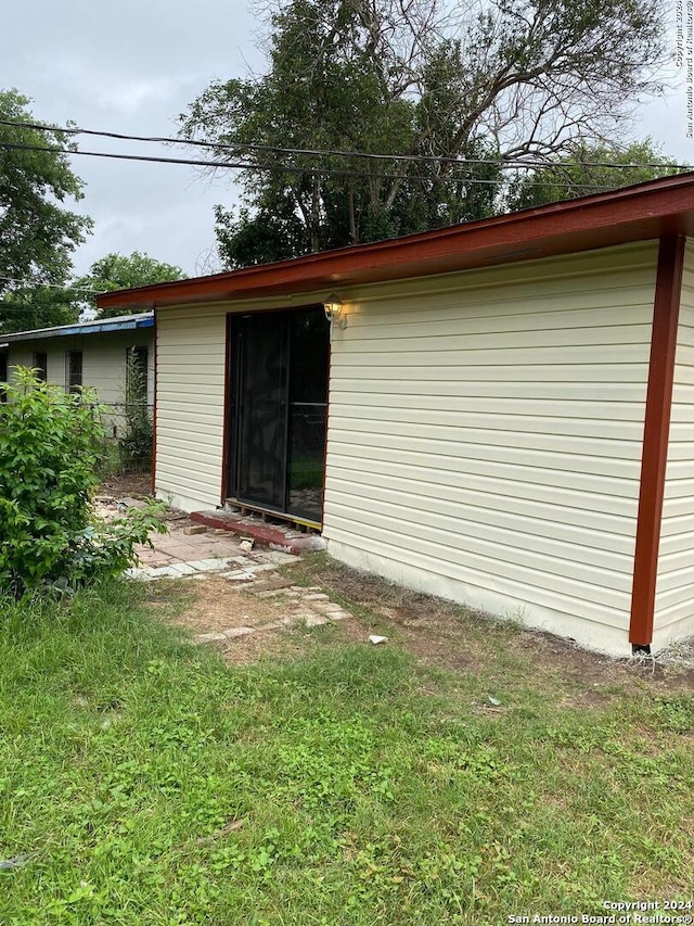 rear view of house featuring a yard