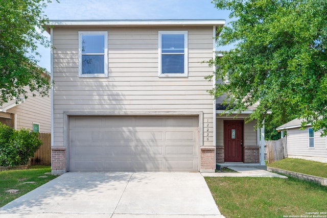 view of front of house featuring a front yard and a garage