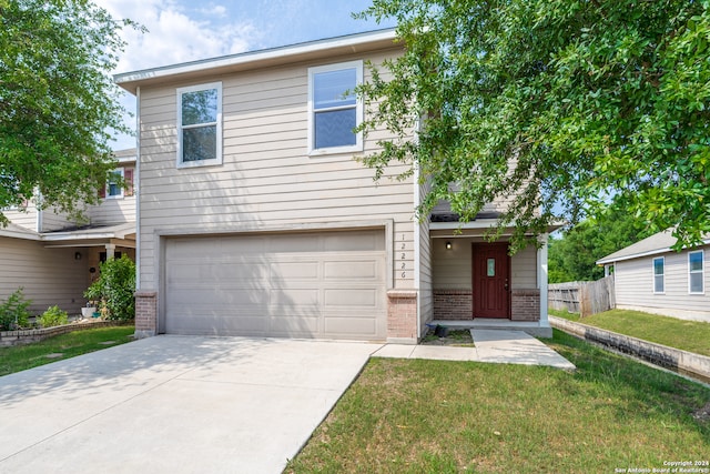 view of front of property with a front yard and a garage