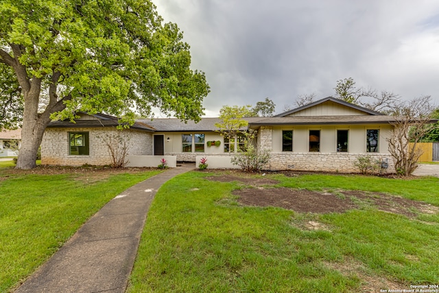 ranch-style house with a front lawn