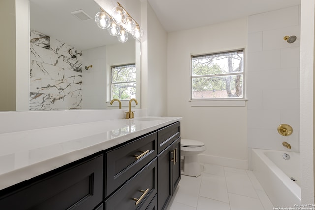 full bathroom with tiled shower / bath, tile flooring, toilet, and vanity