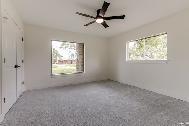 empty room featuring carpet and ceiling fan